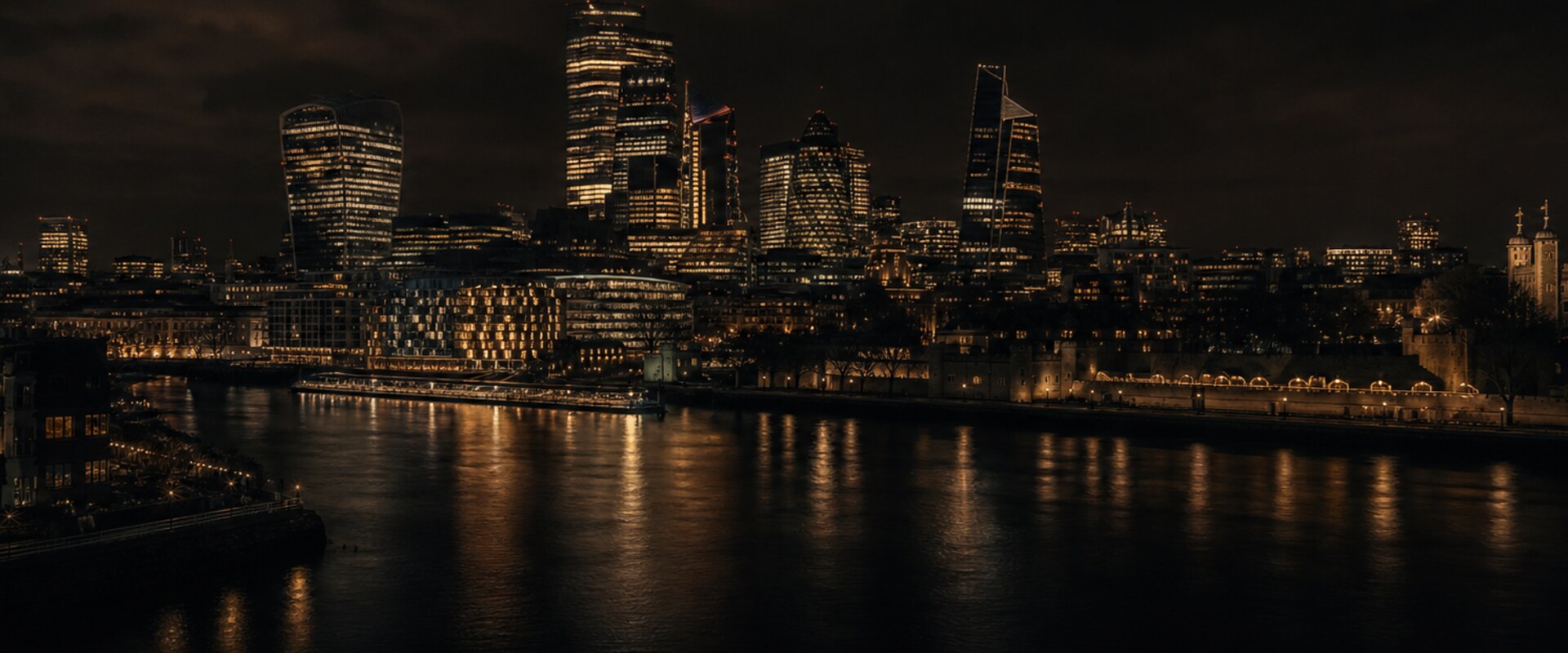 Cinematic dark view of central London at night with the Thames and skyline.
